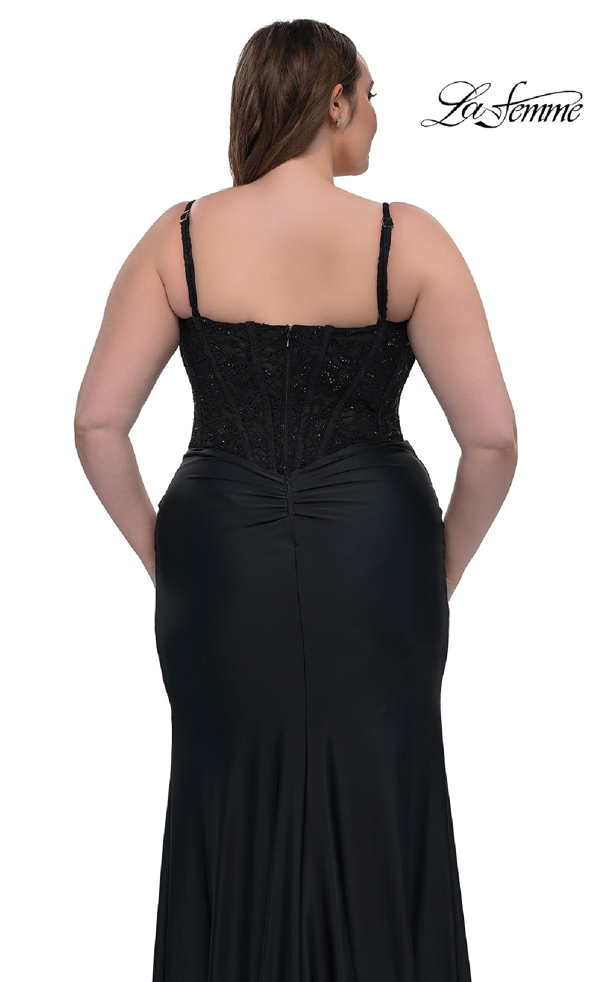 A woman models the La Femme 32449 plus-size long corset prom dress, a black sleeveless fitted gown with beaded bodice detailing, shown from the back against a white background.